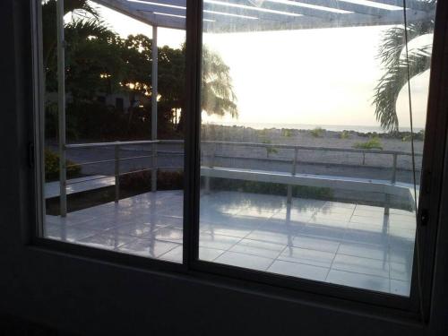 a view of a patio from a window of a house at VILLA SANTORO Casa playa de Castelnuovo-Atacames in Atacames