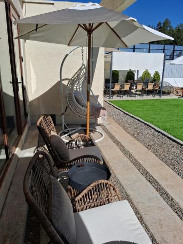 a group of chairs and an umbrella on a patio at The sun in Tomé