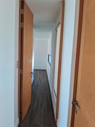 a hallway of an empty room with two doors at The sun in Tomé