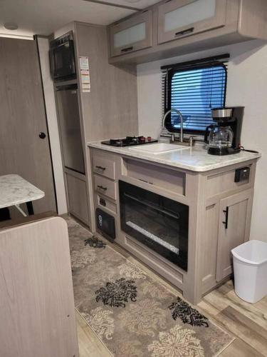 a small kitchen with a sink and a stove at Half Moon Lake property in Melrose