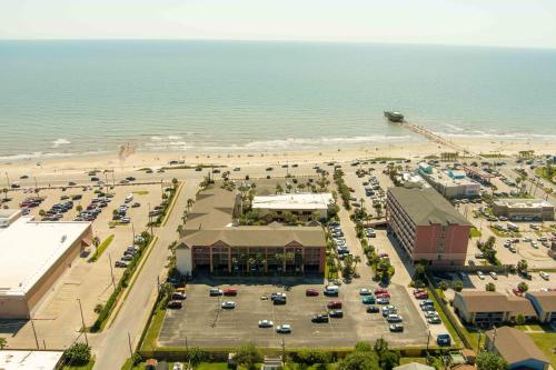 an aerial view of a parking lot next to the beach at Quality Inn & Suites Galveston - Beachfront in Galveston