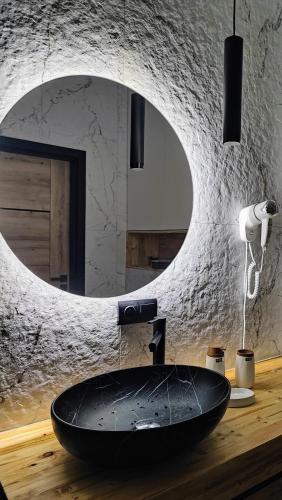 a bathroom with a sink in front of a mirror at Apartament w Bartoszycach in Bartoszyce