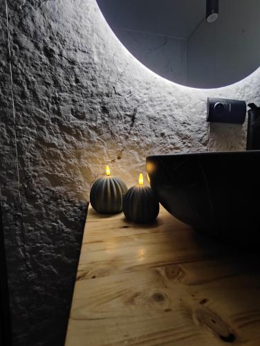 three pumpkins sitting on a table in a room at Apartament w Bartoszycach in Bartoszyce