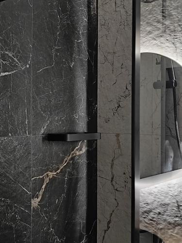 a shower with a glass door in a bathroom at Apartament w Bartoszycach in Bartoszyce