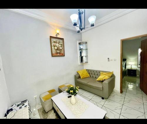 a living room with a couch and a table at Fustelle city 2 in Douala