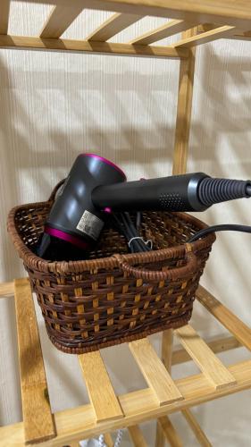 a hair dryer in a basket on a table at Chani House Hatyai in Hat Yai