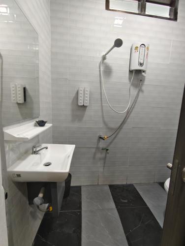 a bathroom with a sink and a shower at Chani House Hatyai in Hat Yai