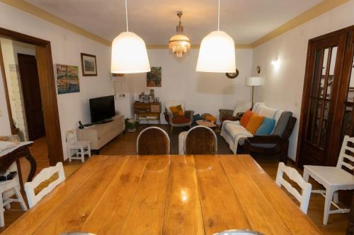 a living room with a wooden table and a couch at Casa Dona Aninhas - Douro in Moura Morta