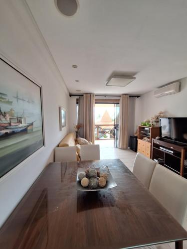 a living room with a dining table and a couch at Costa Oeste Itaparica in Itaparica Town
