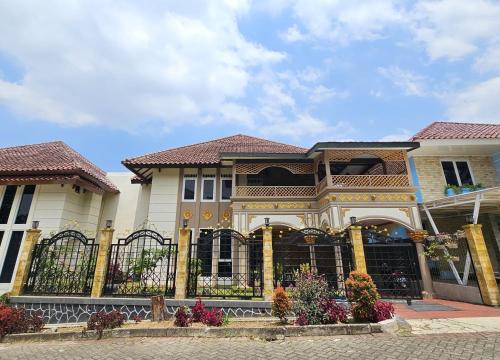 a house with a fence in front of it at Amjad5 in Cipanas