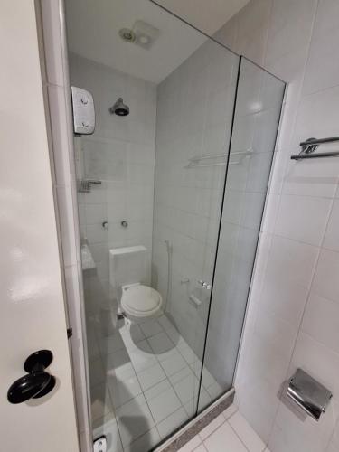 a bathroom with a toilet and a glass shower at Costa Oeste Itaparica in Itaparica Town