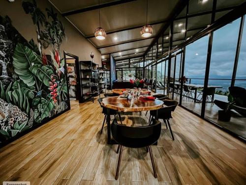 a dining room with a table and chairs and a mural at Private Costa Rica Mountain House Pool & Stunning Views in Turrialba