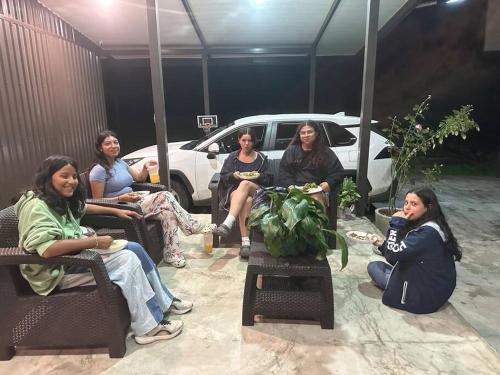 a group of women sitting in chairs in a garage at Private Costa Rica Mountain House Pool & Stunning Views in Turrialba