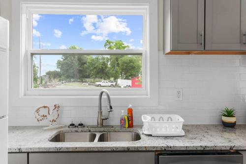 a kitchen counter with a sink and a window at 10 Mins to Downtown Modern in Magic City- Unit A in Birmingham