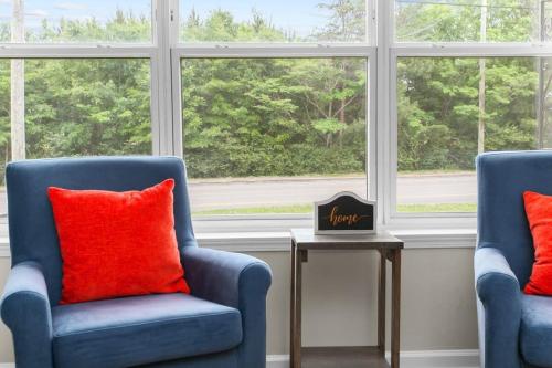 two blue chairs with red pillows in front of a window at 10 Mins to Downtown Modern in Magic City- Unit A in Birmingham