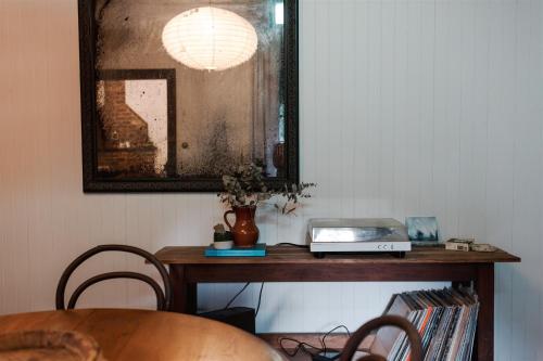 a table with a laptop on it in a room at Baxter Lodge - Hinterland Country Luxury in Mapleton