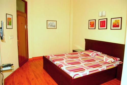 a bedroom with a large bed in a room at Woodpecker Apartments Hauz khas in New Delhi