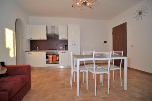 a kitchen with a table and chairs in a living room at Villa Elegance in Ladispoli