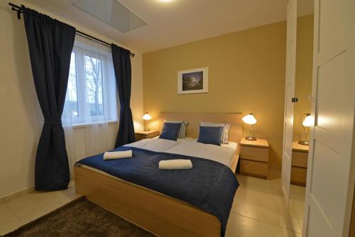 a bedroom with a bed with two pillows on it at Apartmány Belveder in Hlohovec