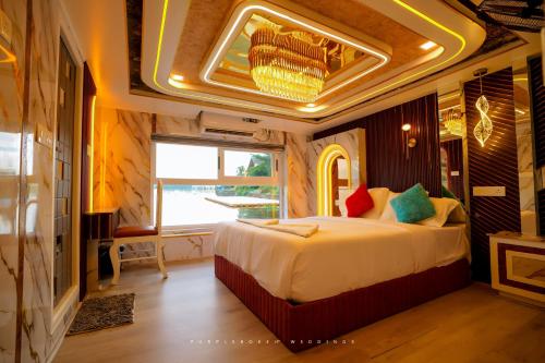 a bedroom with a large bed in a room at Dreams Spectrum Luxury houseboat in Alleppey
