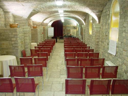 a row of red chairs in a large room at Nouvel Hotel Des Bains in Pesaro