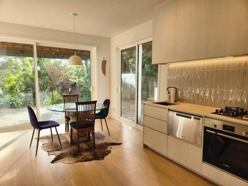 a kitchen with a table and chairs and a dining room at Mt Eden Kingsland At the heart of it all in Auckland