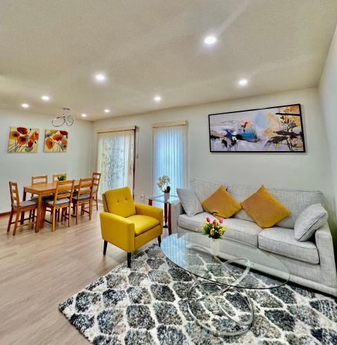 a living room with a couch and a dining room at Entire House-3BRM-14 mins from Niagara Falls in Thorold