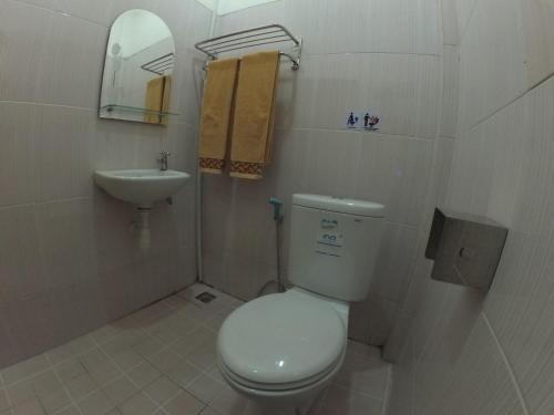 a small bathroom with a toilet and a sink at Belitong Inn in Tanjungpandan