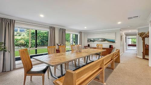 a dining room with a wooden table and chairs at Mount Gibraltar Retreat in Mittagong
