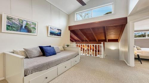a room with a bed and a staircase with windows at Mount Gibraltar Retreat in Mittagong