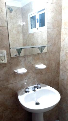 a bathroom with a white sink and a mirror at Gotas de Rocío - Balcón para 4 in San Antonio Oeste