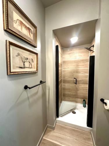 a bathroom with a walk in shower next to a shower at Newly renovated apartment in the heart of Detroit! in Detroit