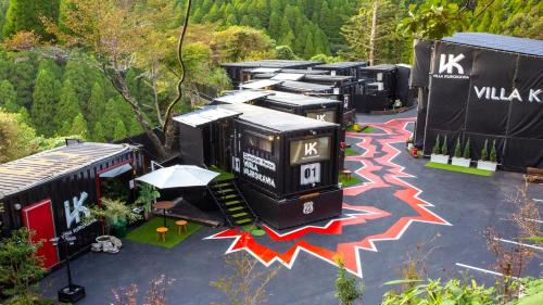 an aerial view of a group of buildings in a parking lot at コンテナハウスヴィラくろかわ in Minamioguni