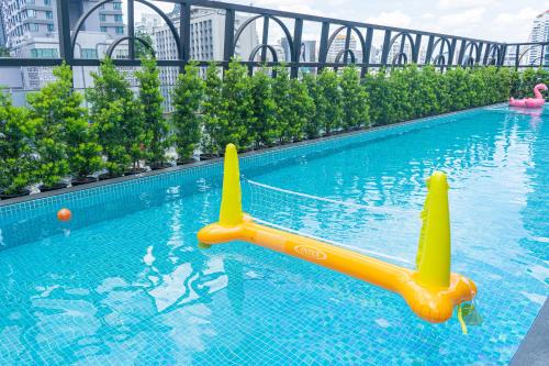 a swimming pool with an inflatable toy in the water at The Salil Hotel Sukhumvit 57 - Thonglor in Bangkok