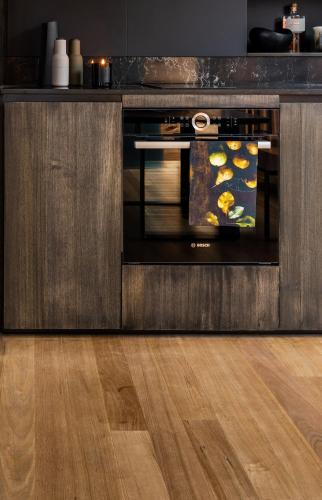 an oven in a kitchen with a wooden floor at The Tailored Pod - A Compact Oasis in Lewisham