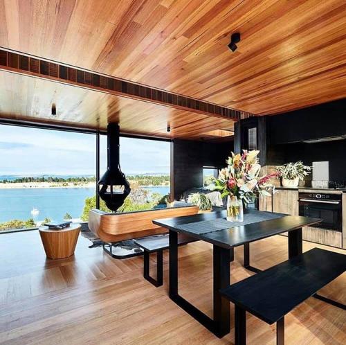a kitchen and dining room with a table and a boat at The Tailored Pod - A Compact Oasis in Lewisham