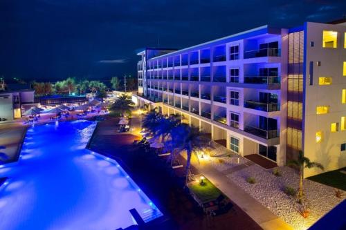 Un gran edificio con piscina por la noche. en GrandBlue Condo 506, en Ban Tha Fat