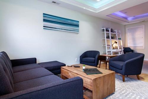 a living room with a couch and two chairs and a table at MODERN HOME NEAR CAPITOL HILL - Walk to METRO subway in Washington, D.C.