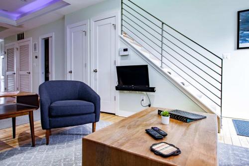 a living room with a blue chair and a table at MODERN HOME NEAR CAPITOL HILL - Walk to METRO subway in Washington, D.C.