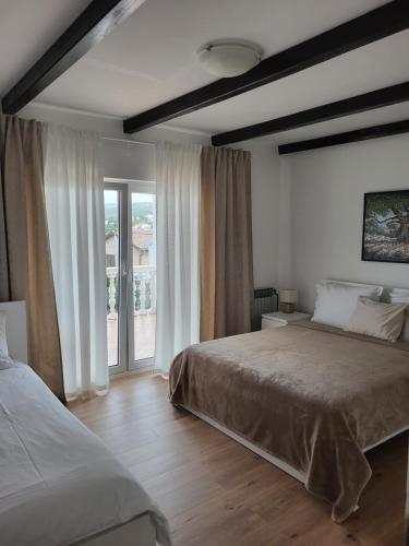 Postel nebo postele na pokoji v ubytování Apartments Vukovic