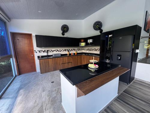 a kitchen with a black and white counter top at Kulcana - Cerros del Guacaná in Tocaima