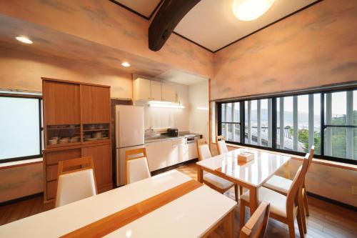 a kitchen and dining room with a table and chairs at 【Newly Opened】Yufuin Geihinkan Kura in Yufuin