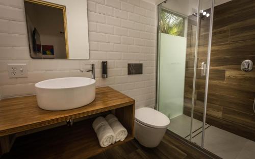 a bathroom with a sink and a glass shower at Somewhere in Bocas del Toro