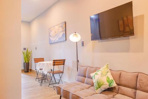 a living room with a couch and a table at Green House - Căn hộ có bếp riêng in Da Lat