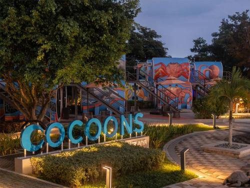 a sign that reads crosons at night at Cocoons Club Laiya in Batangas City