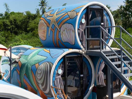 a blue slide with a painting on it at Cocoons Club Laiya in Batangas City
