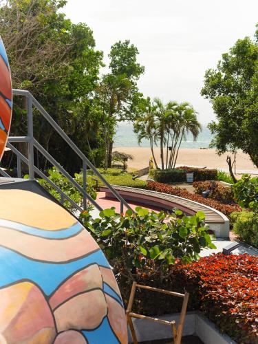 a garden with a colorful painting on the steps to the beach at Cocoons Club Laiya in Batangas City