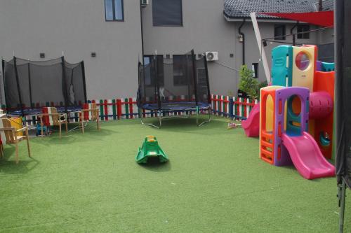 a playground with a play equipment in a building at Eataly Cazare Bals in Balş