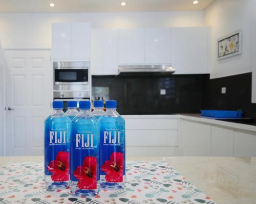 two bottles of water on a table in a kitchen at First home Fiji in Nadi