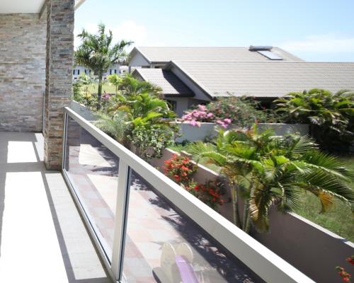 a balcony with plants and flowers on a building at Happiness Home FiJi in Narewa